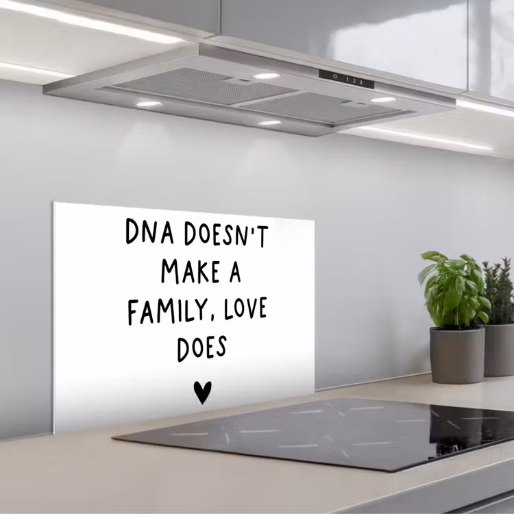 Kitchen splashback for hob - English quote "DNA doesn't make a family, love does" with a heart on a white background — 1